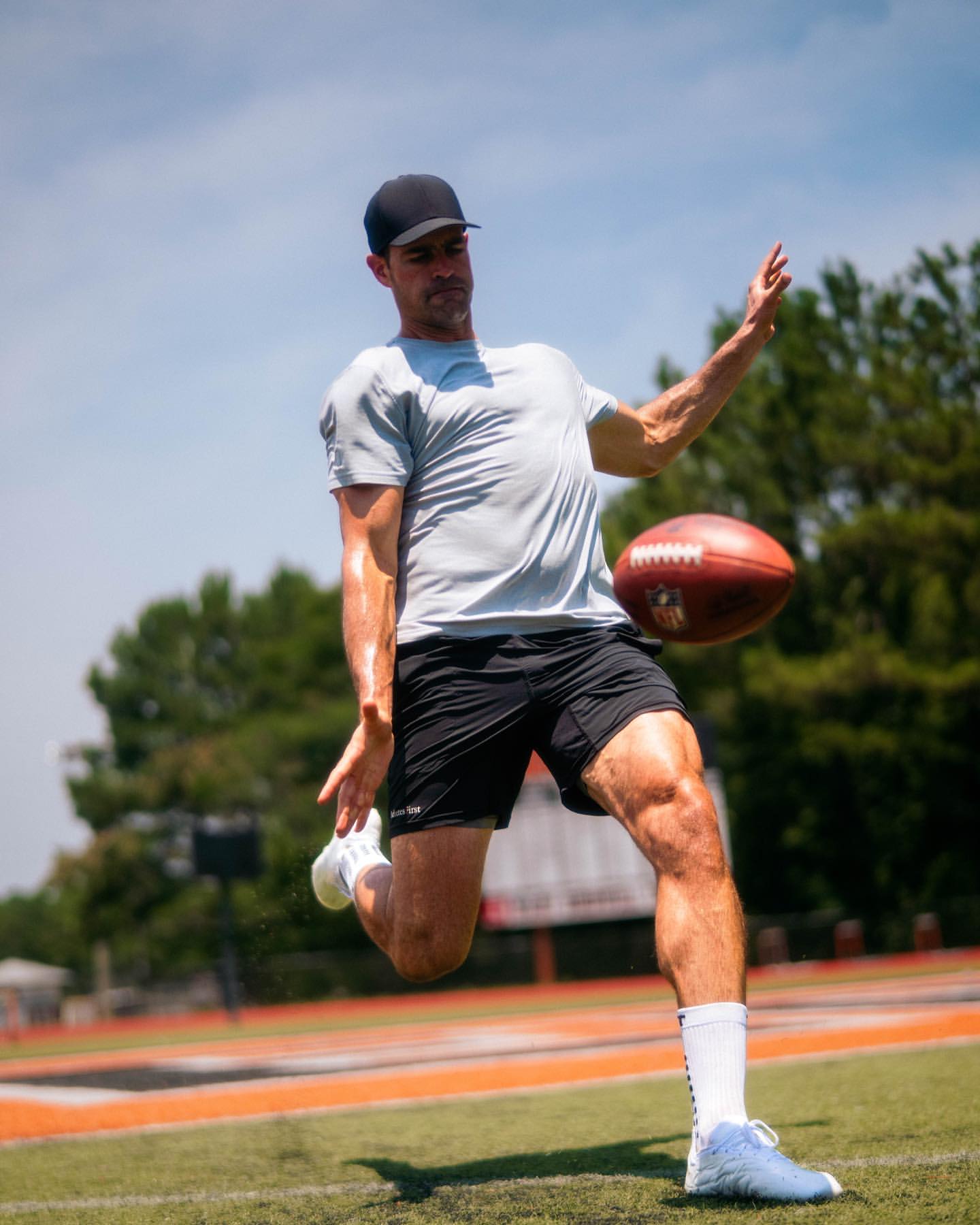 Pat O'Donnell, NFL punter #16, mid-punt with the ball in the air